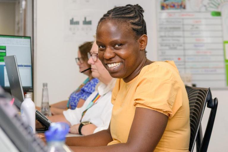 Lady sitting at desk and smiling