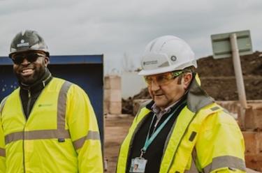 Men in hi-viz and hard hats discuss current vacancies at Oxfordshire